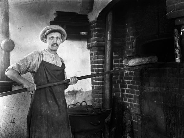 Afbeelding van een bakker aan het werk uit de collectie van Schröer